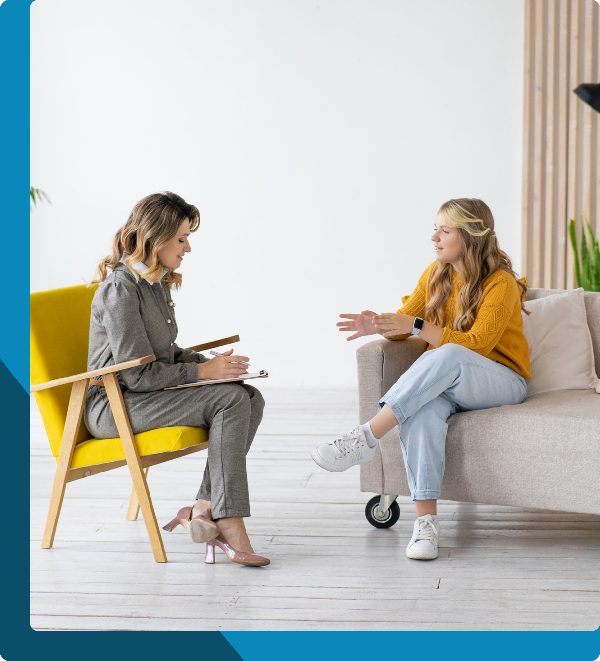 Two women engaged in a friendly conversation in a cozy living room.